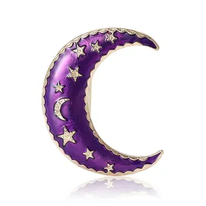 Elegant gold crescent moon brooch with purple enamel finish and sparkling crystals