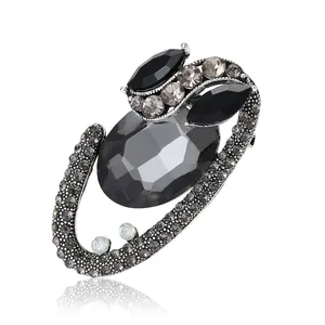 Vintage oval gray gemstone brooch with rhinestones in retro silver setting on white background