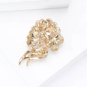 Detail view of the secure safety pin clasp and hollow alloy structure on the flower brooch