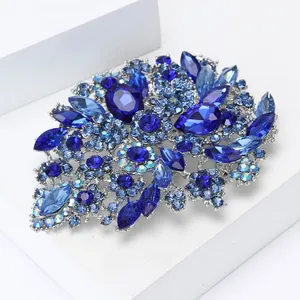 Detailed view of large alloy brooch with multi-layered blue rhinestones and crystals