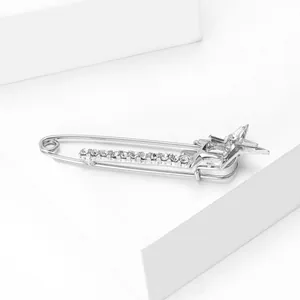 Detail of silver alloy star brooch with rhinestones for elegant suit decoration