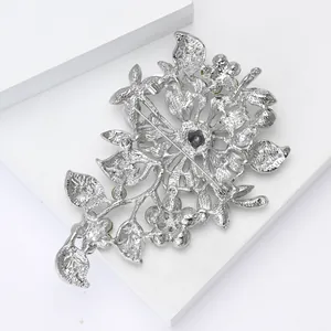 Detailed back view of silver alloy floral brooch showing intricate cutout and pin clasp