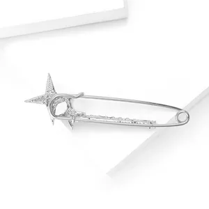 Macro shot of silver rhinestone star pin with polished metal finish on white backdrop