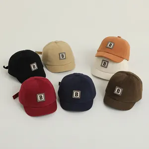 Group of colorful soft brim baby baseball caps with embroidered letter B patches