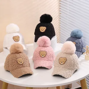 Collection of children's fleece baseball caps with faux fur pom-pom and bear embroidery