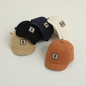 Detail view of cotton baby baseball caps in five colors with leather letter B patch