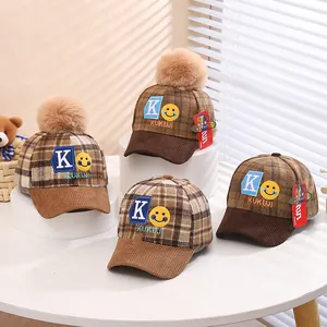 Children's winter plaid baseball caps with brown pompom and blue 'K' embroidery