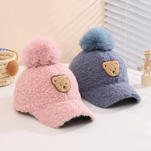 Kids plush baseball cap with fluffy pom-pom and cute bear patch in pink and blue