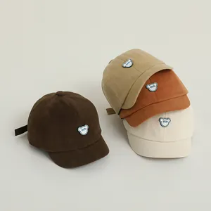 Set of baby baseball caps with bear patches in brown, khaki, orange and white colors