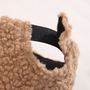 Detail of warm caramel plush fabric with adjustable elastic strap and Velcro closure