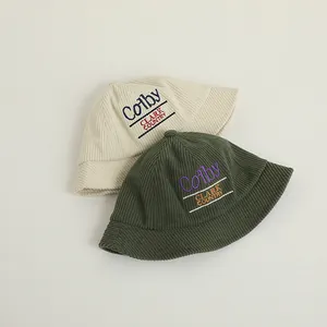 Detailed view of corduroy bucket hats with Colby Clark embroidery in beige and dark green