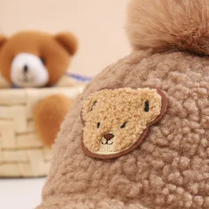 Cozy camel fleece baby baseball cap with plush pom-pom and cute bear embroidery patch