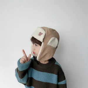 Detailed view of kids corduroy aviator hat with soft faux shearling lining and bear embroidery