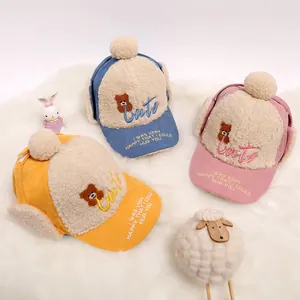 Three children corduroy earflap hats with cute bear embroidery in blue yellow and pink