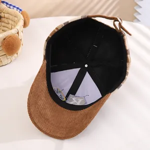 Detail of baby winter cap showing inner lining, cross stitching, and corduroy strap