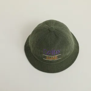 Detailed view of dark green corduroy hat with embroidered Colby Clark Country logo