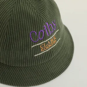 Detailed view of dark green corduroy bucket hat with high-quality letter embroidery