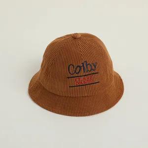 Detailed view of caramel corduroy bucket hat with Colby and Clark Country embroidery