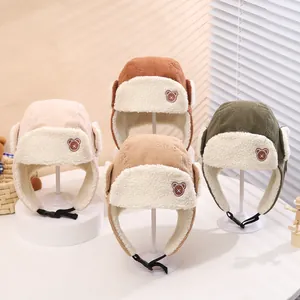 Detailed view of corduroy baby trapper hats with warm faux shearling lining and earflaps
