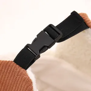 Detail of adjustable buckle and strap on kids corduroy winter hat with fleece lining