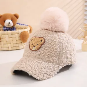 Detail of soft fleece toddler baseball cap with plush pompom and bear embroidery