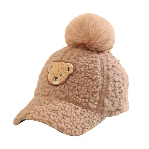 Winter plush baseball cap for kids with pom-pom and bear embroidery in brown color