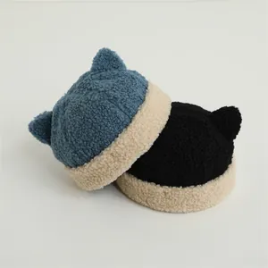 Close-up of cozy fleece toddler caps with cute cat ear details and rolled brims