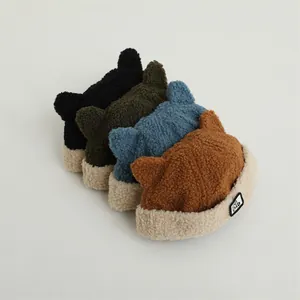 Winter fleece hats for kids with M label and ox horns in four assorted colors