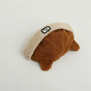 Detail of winter fleece children's cap with soft lamb wool texture and 'M' patch logo