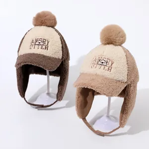 Close-up of winter thermal earflap hat featuring soft fleece and otter embroidery