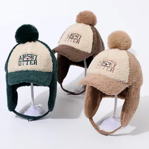 Plush fleece winter earflap caps for kids featuring fuzzy pom-poms and cute embroidery