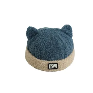 Cute kids fleece hat with M logo and horns in misty blue and beige contrast