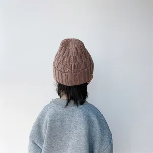 Detailed back view of kids brown cable knit beanie with thick ribbed cuff texture