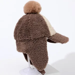 Winter fleece baseball cap for kids with pom pom and earflaps in brown and white