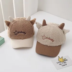 Detail of plush baby baseball caps with 3D horns, velvet texture, and Cutebaby embroidery