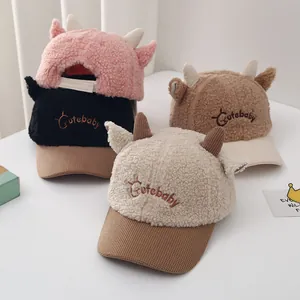 Collection of fuzzy baby baseball hats with cute horns in pink, black, brown, and beige
