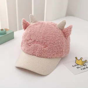 Close-up of pink plush baby baseball cap with cute horns and Cutebaby embroidery detail