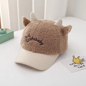 Detail of baby plush baseball cap showing teddy fleece texture and cute horns