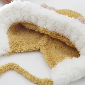 Detail of soft faux shearling material and neat stitching on warm winter baby hat