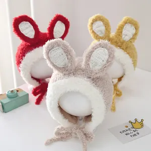 Detailed close-up of colorful plush baby earflap hats with cute 3D bunny ears decoration
