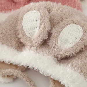 Detail of plush fleece rabbit ears with knit lining on a winter baby trapper hat