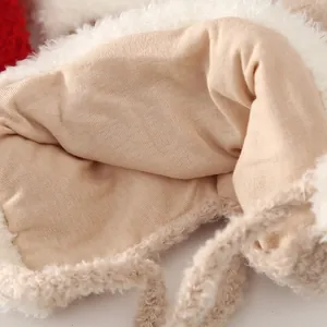Close-up of the plush fleece lining and warm knit fabric of this winter baby trapper hat