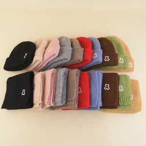 Detailed knit texture and embroidered bear logo on children winter hat and scarf set