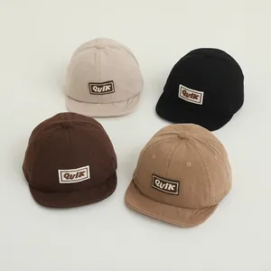 Corduroy toddler baseball caps with soft brim and K letter tag in four neutral colors