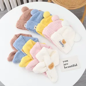 Detail of soft winter beanies and scarves set with Lucky bear patches in five colors