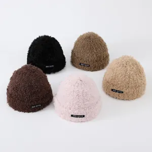 Detail view of colorful plush knit beanies with soft texture and logo labels