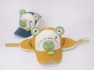 Close-up of fluffy winter frog trapper hats with earflaps and adjustable chin straps