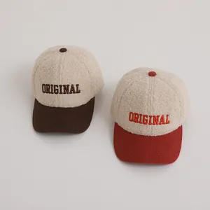 Detail of winter baseball caps showing sherpa texture and corduroy brims with embroidery