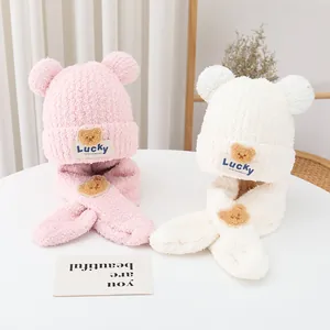 Detail of soft plush bear ear knit hat and scarf sets in pink and white colors