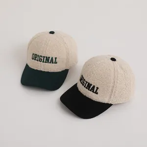 Detail of winter baseball caps with lamb wool crown and corduroy brim with embroidery